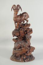 A SUPERB 19TH CENTURY BLACK FOREST CARVING OF A PAIR OF MOUNTAIN GOATS one standing, the other