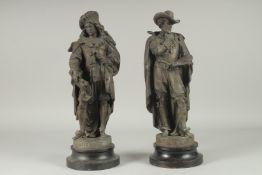 A PAIR OF SPELTER BRONZED FIGURES, REMBRANDT AND RUBENS, on circular bases. 17ins high.