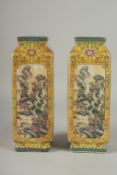 A PAIR OF CHINESE LONG SQUARE SHAPED VASES with landscape views and calligraphy. 12ins high.