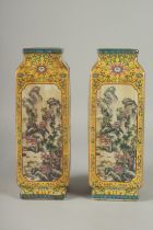 A PAIR OF CHINESE LONG SQUARE SHAPED VASES with landscape views and calligraphy. 12ins high.