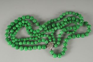 A VERY GOOD TRIPLE, DOUBLE ROW JADE NECKLACE with white gold and diamond clasp.