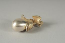 A SILVER HELMET AND EGG PENDANT.
