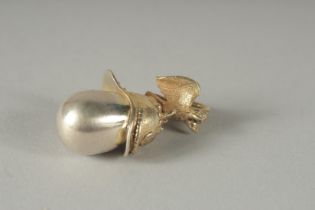A SILVER HELMET AND EGG PENDANT.