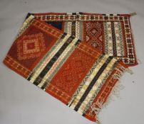 A PERSIAN/ NORTH AFRICAN WOOL RUNNER with bands of sylised decoration. 9ft 10ins x 2ft 8ins.