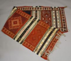 A PERSIAN/ NORTH AFRICAN WOOL RUNNER with bands of sylised decoration. 9ft 10ins x 2ft 8ins.