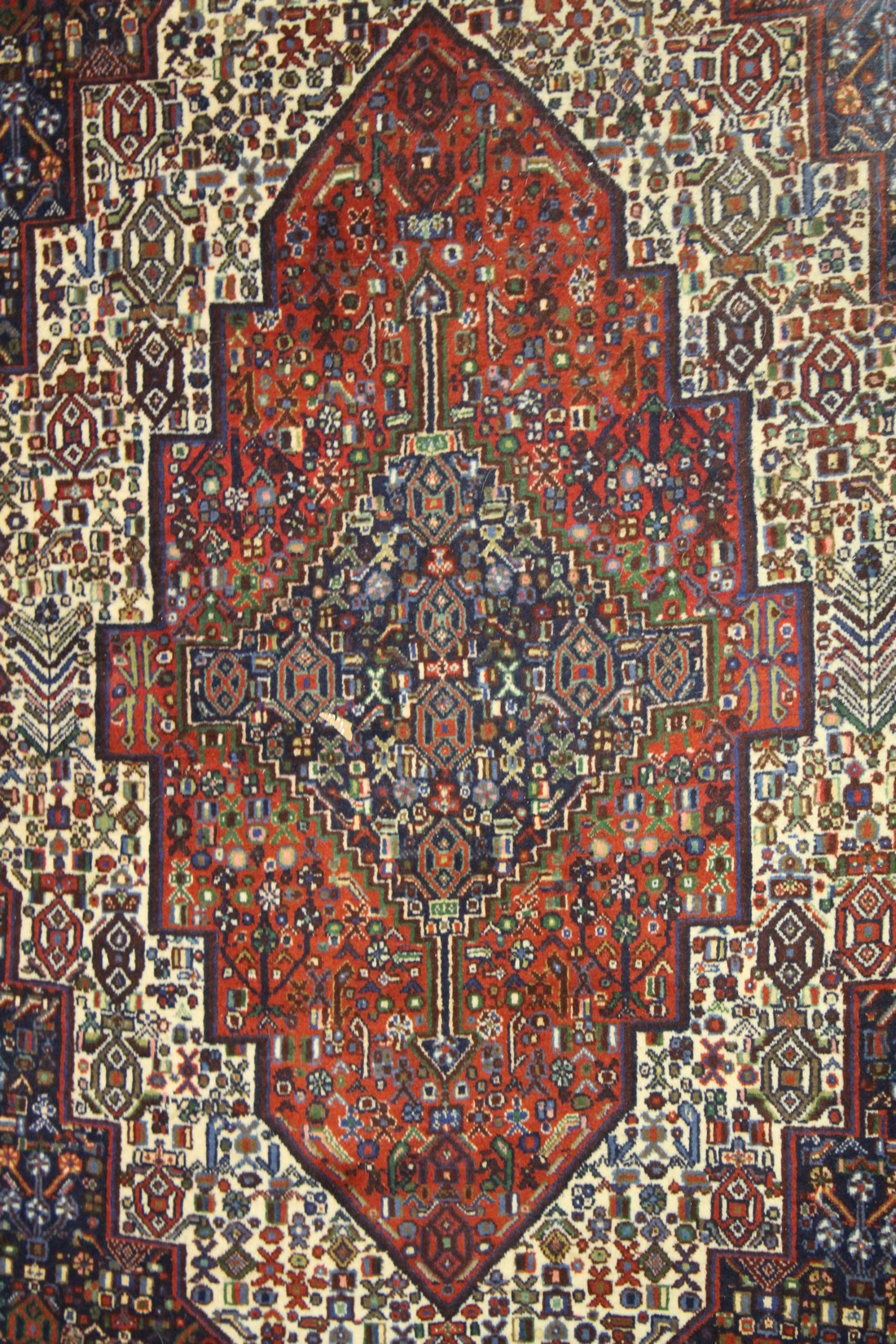 A PERSIAN WOOL CARPET cream, red and blue ground with all over stylised decoration. 4ft 9ins x 4ft - Image 2 of 3
