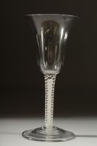 A GEORGIAN WINE GLASS with inverted bell shape bowl and white twist stem. 6ins high.