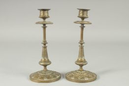 A PAIR OF BRASS CIRCULAR CANDLESTICKS. 8.5ins high on resin bases. and a JUG, 6ins and a VASE AND