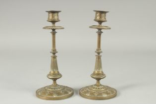 A PAIR OF BRASS CIRCULAR CANDLESTICKS. 8.5ins high on resin bases. and a JUG, 6ins and a VASE AND