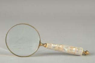 A MAGNIFYING GLASS with mother of pearl handle.