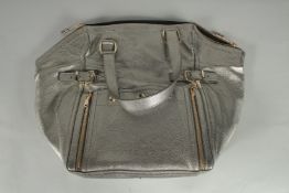 A LARGE SILVERED LEATHER YVES ST. LAURENT BAG with black interior. 17ins long, 13ins high.