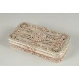 A WHITE METAL FILLIGREE RECTANGULAR BOX, with hinged cover, inset with a red stone. 4.25ins x 2.