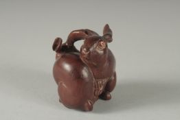 A CARVED WOOD TWO RABBIT NETSUKE, Signed, 2ins high.