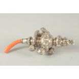 A VICTORIAN SILVER AND CORAL BABIES RATTLE.