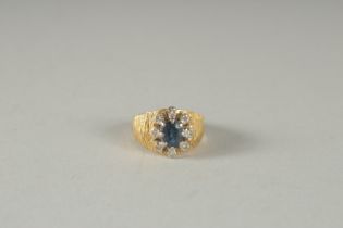 AN 18CT GOLD SAPPHIRE, DIAMOND CLUSTER RING.