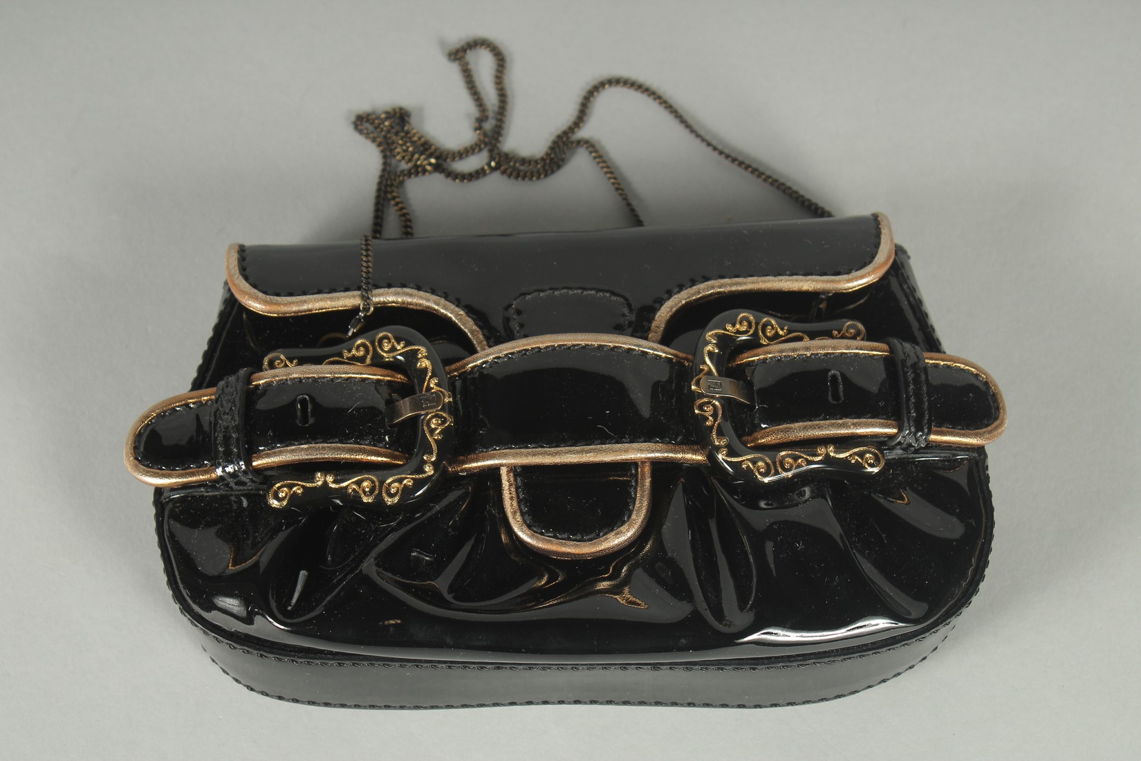 A SMALL FENDI BLACK PATENT LEATHER BAG with double buckle front 8ins long, 5ins high, 2ins deep in