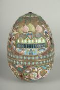 A LARGE RUSSIAN SILVER AND ENAMEL EGG, decorated with panels of white swans and Russian orthodox