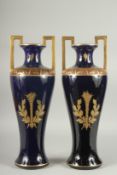 A GOOD PAIR OF FRENCH DEEP BLUE TWO HANDLED CLASSICAL VASES. decorated with burning torches and hand