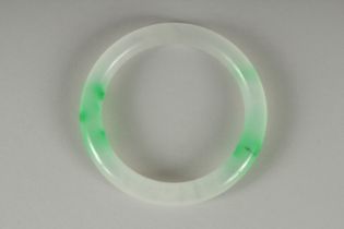 A TWO TONE JADE BANGLE. 7cm diameter.