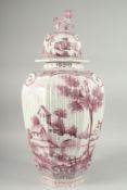A LARGE DUTCH POTTERY RIBBED VASE AND COVER with reverse scenes of buildings, the lid with kylin