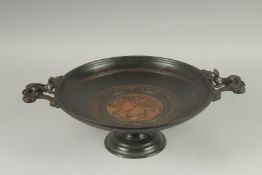 A LARGE BRONZE CLASSICAL, TWO HANDLED CIRCULAR TAZZAS, the centre with a Roman head and three