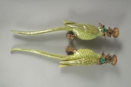 A GOOD PAIR OF PORCELAIN GREEN PARROT WALL SCONCES with gilt metal surrounds. 18.5ins long.