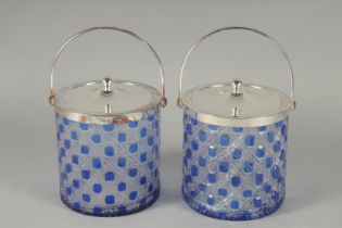 A PAIR OF CUT GLASS BISCUIT BARRELS.