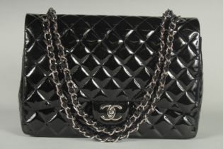 A SUPERB CHANEL BLACK PATENT LEATHER BAG with chrome double C, chrome and leather handle. 13ins