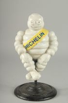 A PAINTED CAST IRON MICHELLIN MAN. 11ins high.