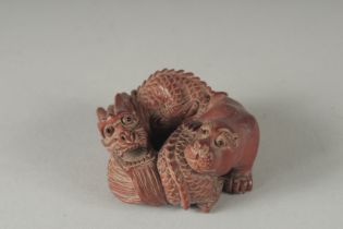 A CARVED WOOD BEAR AND DRAGON NETSUKE, Signed, 2ins.