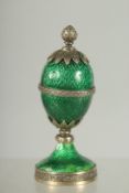 A SUPERB RUSSIAN SILVER AND ENAMEL EGG on a stand by FABERGE. 8cm high. Work maker: HENRIK