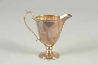 A SILVER PEDESTAL CREAM JUG. Birmingham 1930, 4ins high.