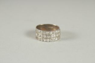 AN 18CT WHITE GOLD TRIPLE ROW DIAMOND RING.