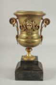 A 19TH CENTURY BRONZE TWO HANDLED URN on a marble stand.