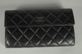 A CHANEL BLACK QUILTED PURSE with chrome double C detail. Card with ref: 16485504. 7.5ins long
