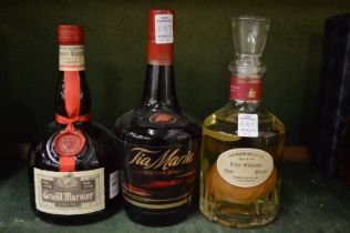 A bottle of Grand Marnier, bottle of Tia Maria and a pear liqueur.