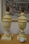 A pair of alabaster urn shaped table lamps.