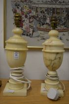 A pair of alabaster urn shaped table lamps.