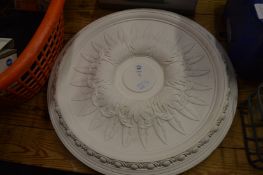 A pair of large moulded plaster ceiling roses.