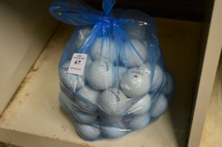 A bag of Titleist Pro V1 and other golf balls.