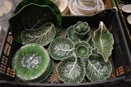 A quantity of cabbage leaf plates and serving dishes.