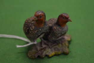 A cold painted cast bronze model of partridges.