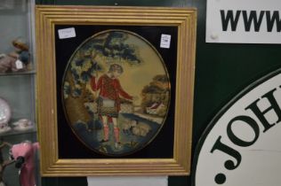 An embroidered picture of a shepherd in verre eglomise frame.