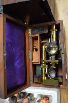 A mahogany cased brass microscope.