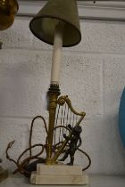 A good small table lamp modelled as a bronze cherub playing a harp on a marble base.