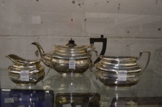 A silver three piece tea service.