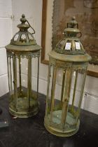 A pair of metal candle lanterns.