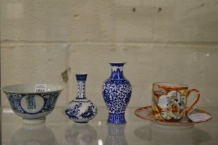 A small Chinese blue and white bowl, two small blue and white vases and Japanese cup and saucer.