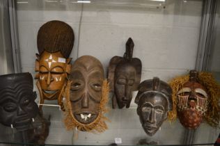 A good collection of six African and other carved wood and painted masks.