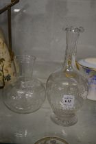 An etched glass decanter and a similar carafe.